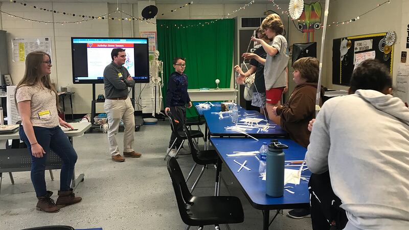 Engineers from Fleet Readiness Center East (FRCE) speak with students at Pamlico Middle School.