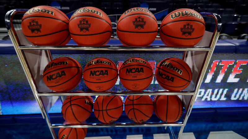 Game balls are displayed on a rack before a regional championship game between Notre Dame and...