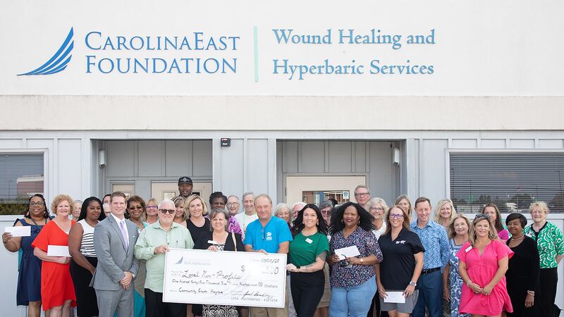 Representatives from the nonprofit organizations and programs gathered with Jared Brinkley,...