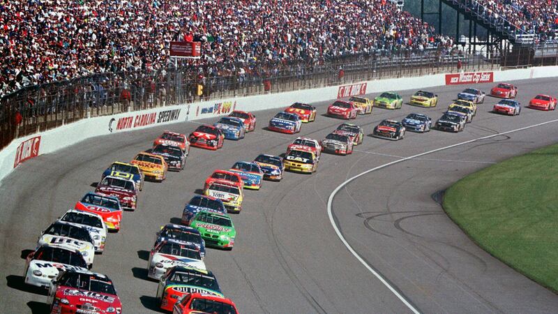FILE - Ricky Rudd, front right, and Jeff Burton, front left, lead the field as they take the...