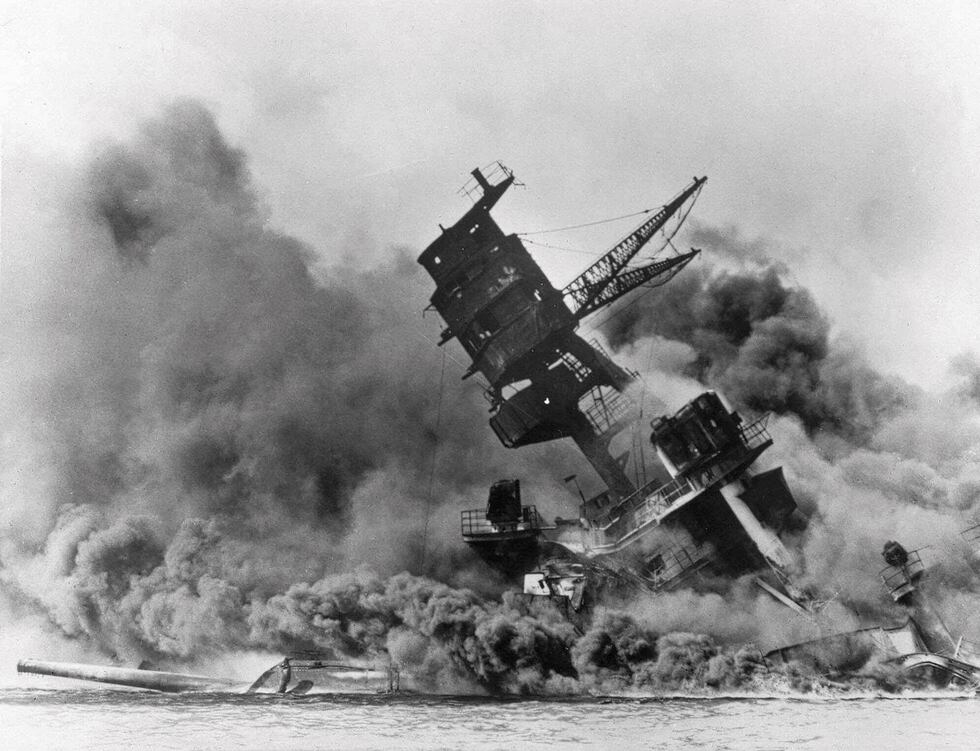 FILE - In this photo provided by the U.S. Navy, smoke rises from the battleship USS Arizona as...